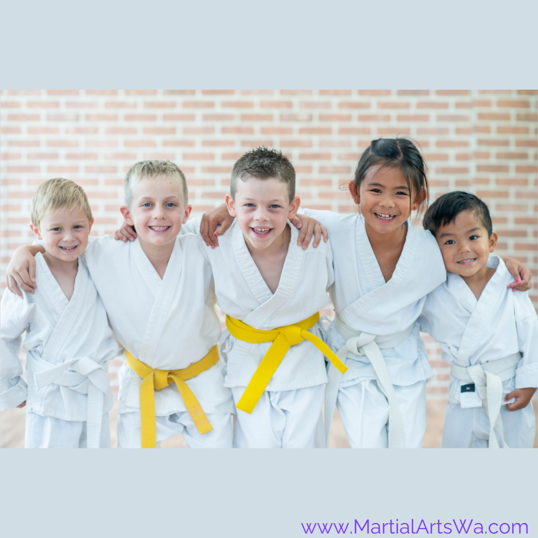 Group of diverse children in martial arts uniforms standing together akma
